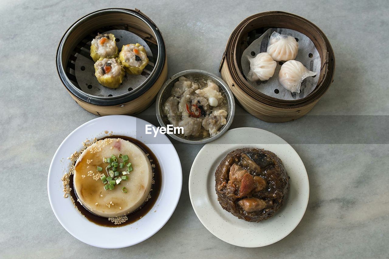 High angle view of various chinese dishes on marble