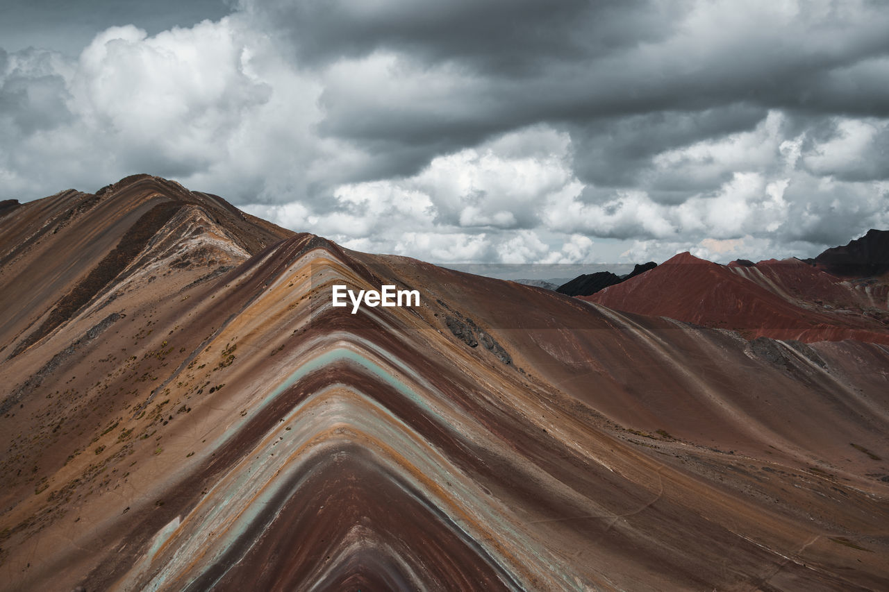 Scenic view of mountains against cloudy sky