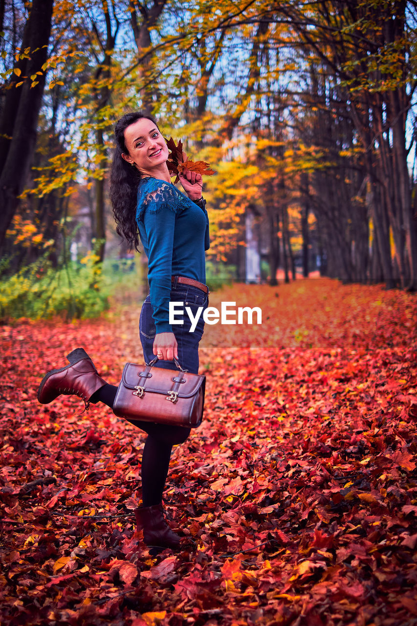 Full length of woman in park during autumn