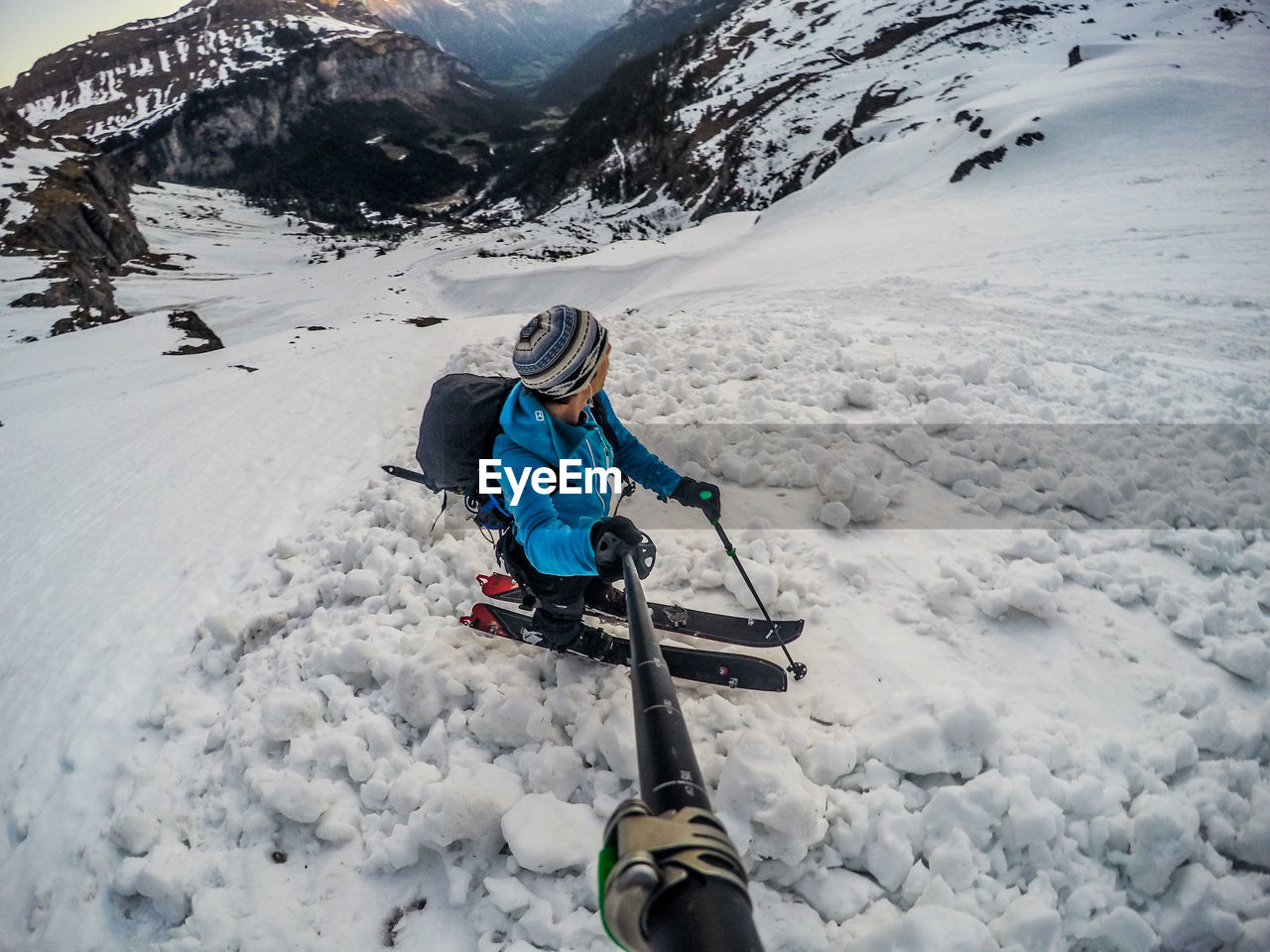 Full length of man stanidng on snowcapped mountain