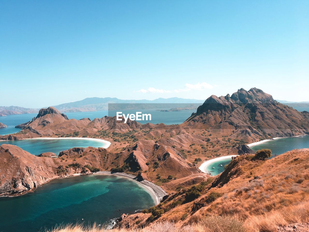 Panoramic view of landscape and mountains against clear blue sky