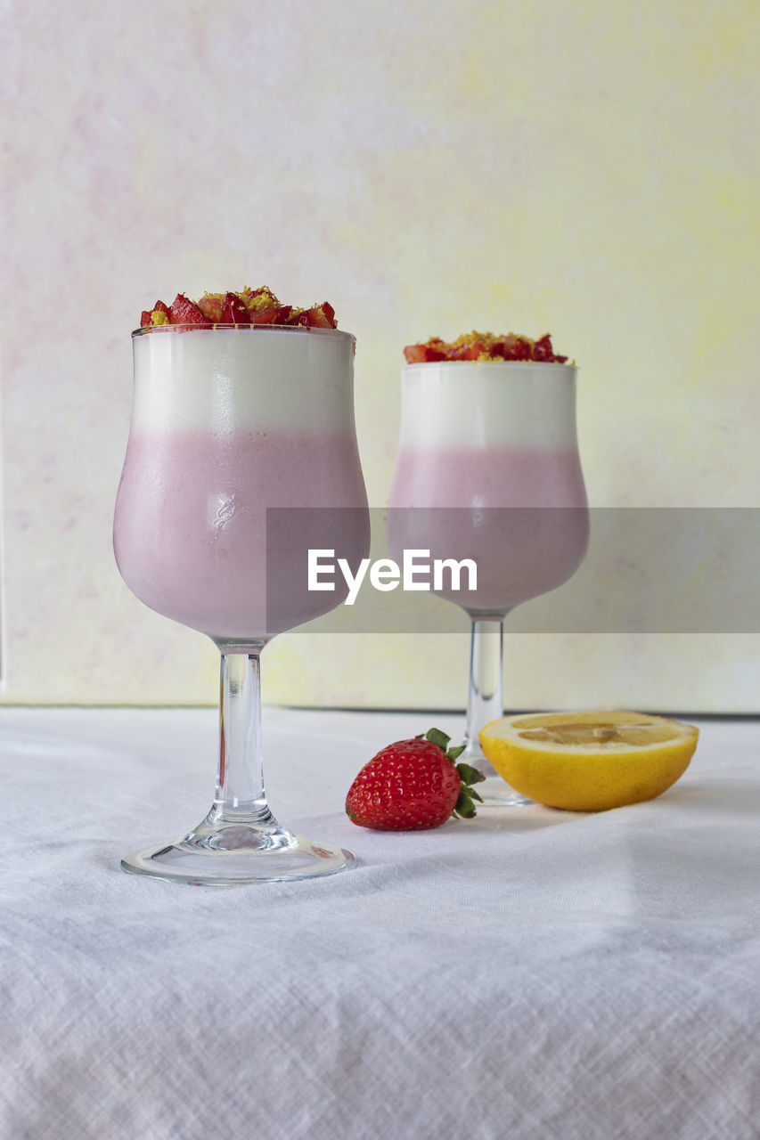 Two glasses with pink straberries mousse.