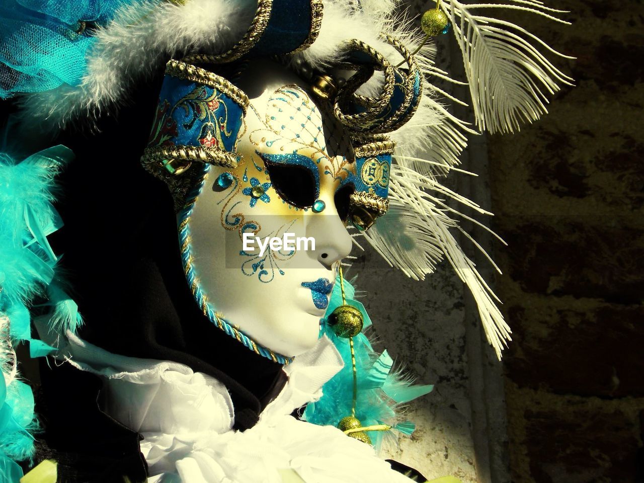 Person wearing venetian mask in carnival