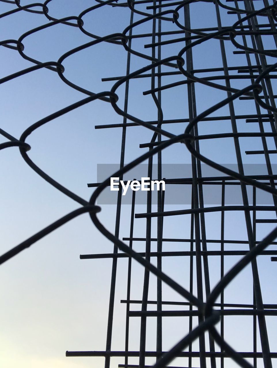 LOW ANGLE VIEW OF SILHOUETTE FENCE AGAINST SKY