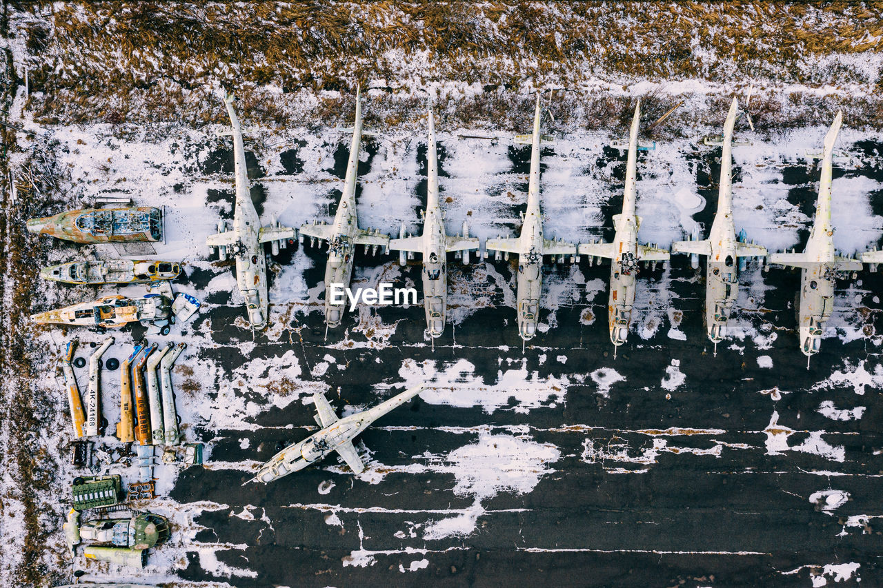 Aerial view of abandoned helicopters on land during winter