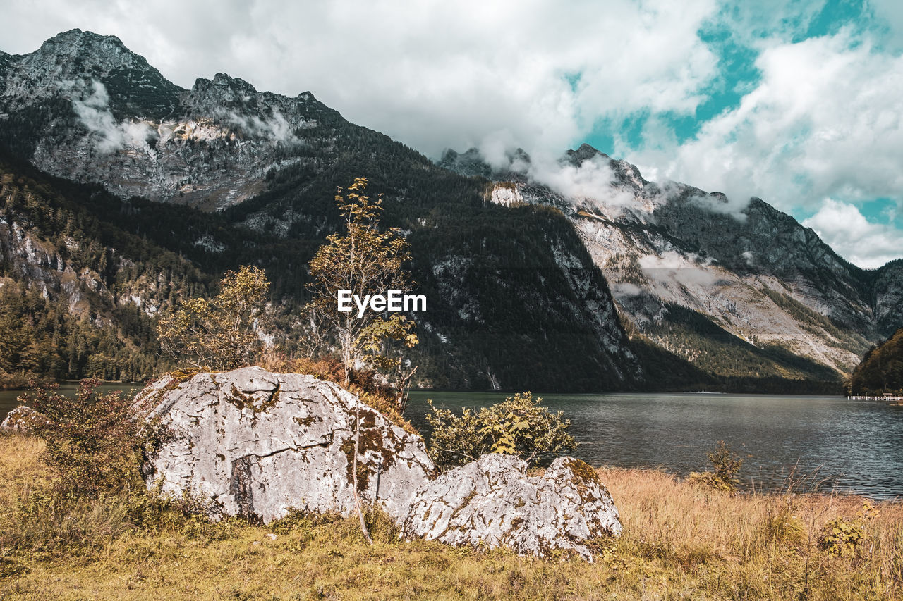 Scenic view of lake by mountains against sky