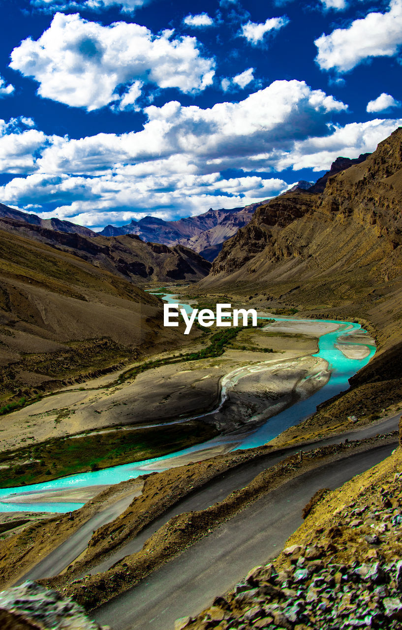 Scenic view of landscape and mountains against blue sky