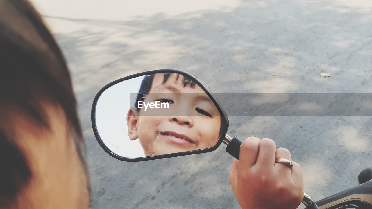 Portrait of boy with reflection on glass