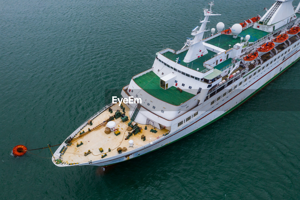 HIGH ANGLE VIEW OF SHIP MOORED AT SEA