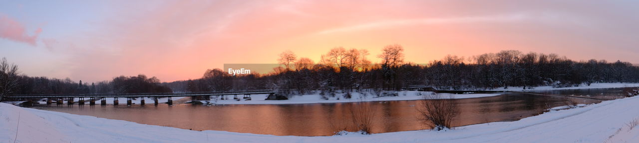 Scenic view of lake against sky during winter