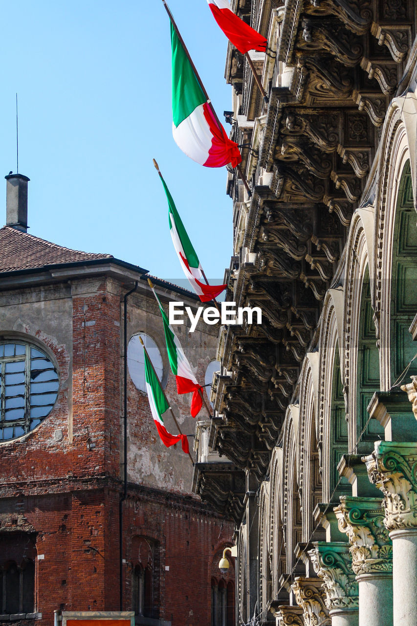 LOW ANGLE VIEW OF FLAGS AGAINST BUILDING