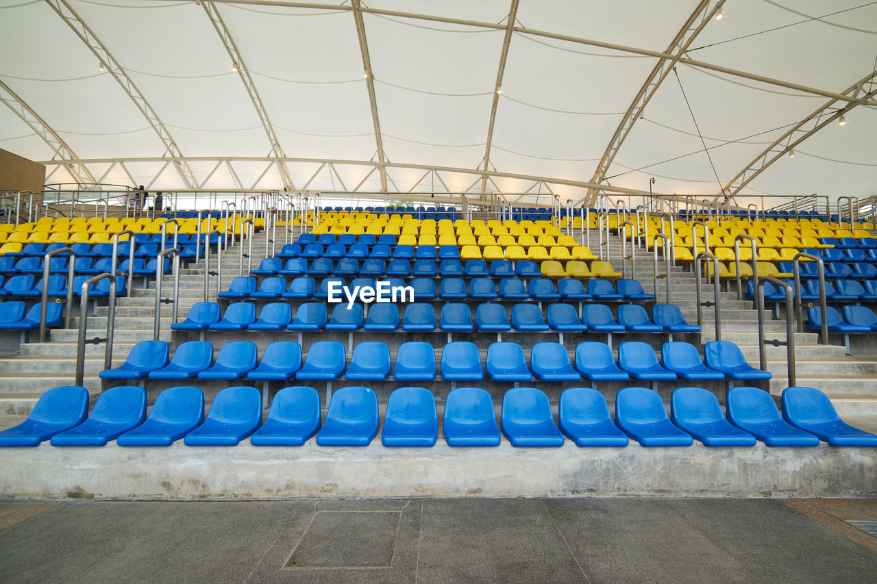 Low angle view of empty chairs in stadium