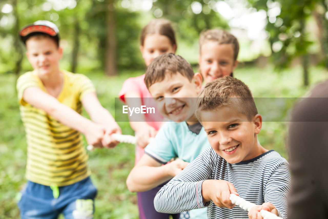 REAR VIEW OF PEOPLE WITH CHILDREN ON GROUP OF FRIENDS