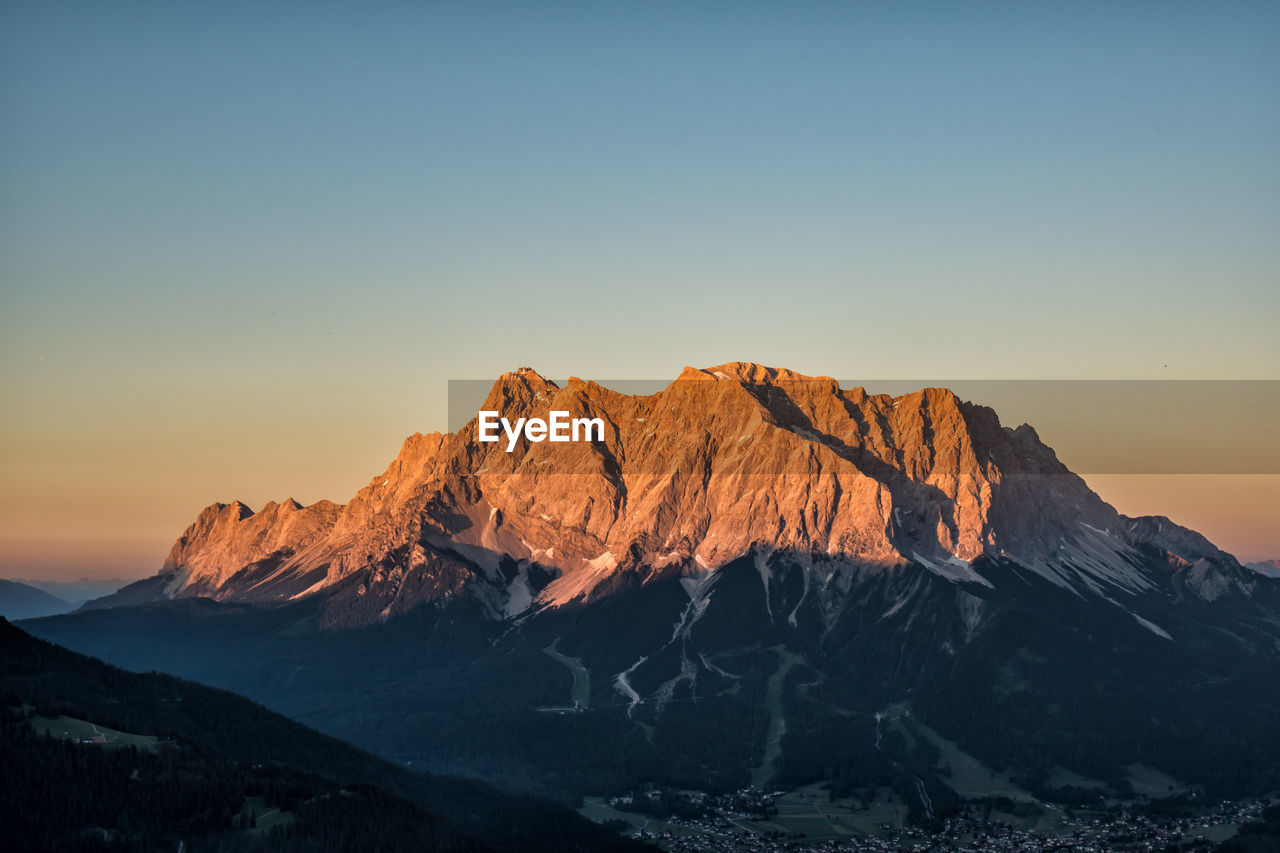 Scenic view of mountain against clear sky during sunset