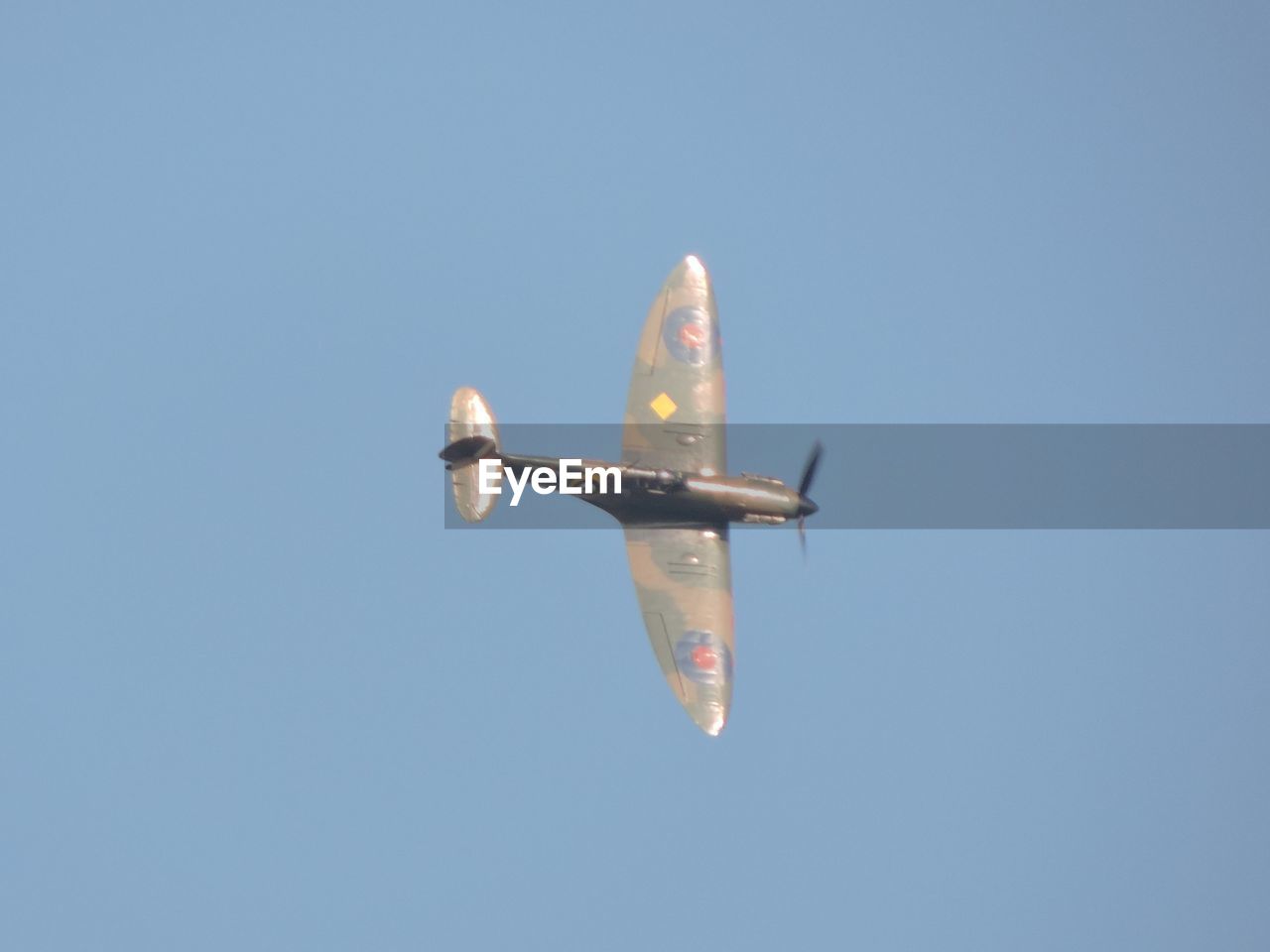 LOW ANGLE VIEW OF PARACHUTE AGAINST BLUE SKY