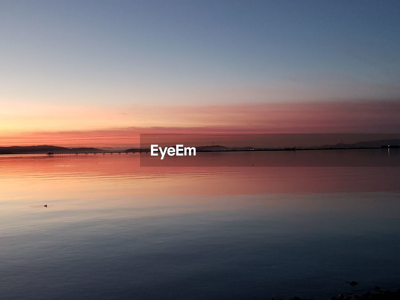 Scenic view of sea against romantic sky at sunset