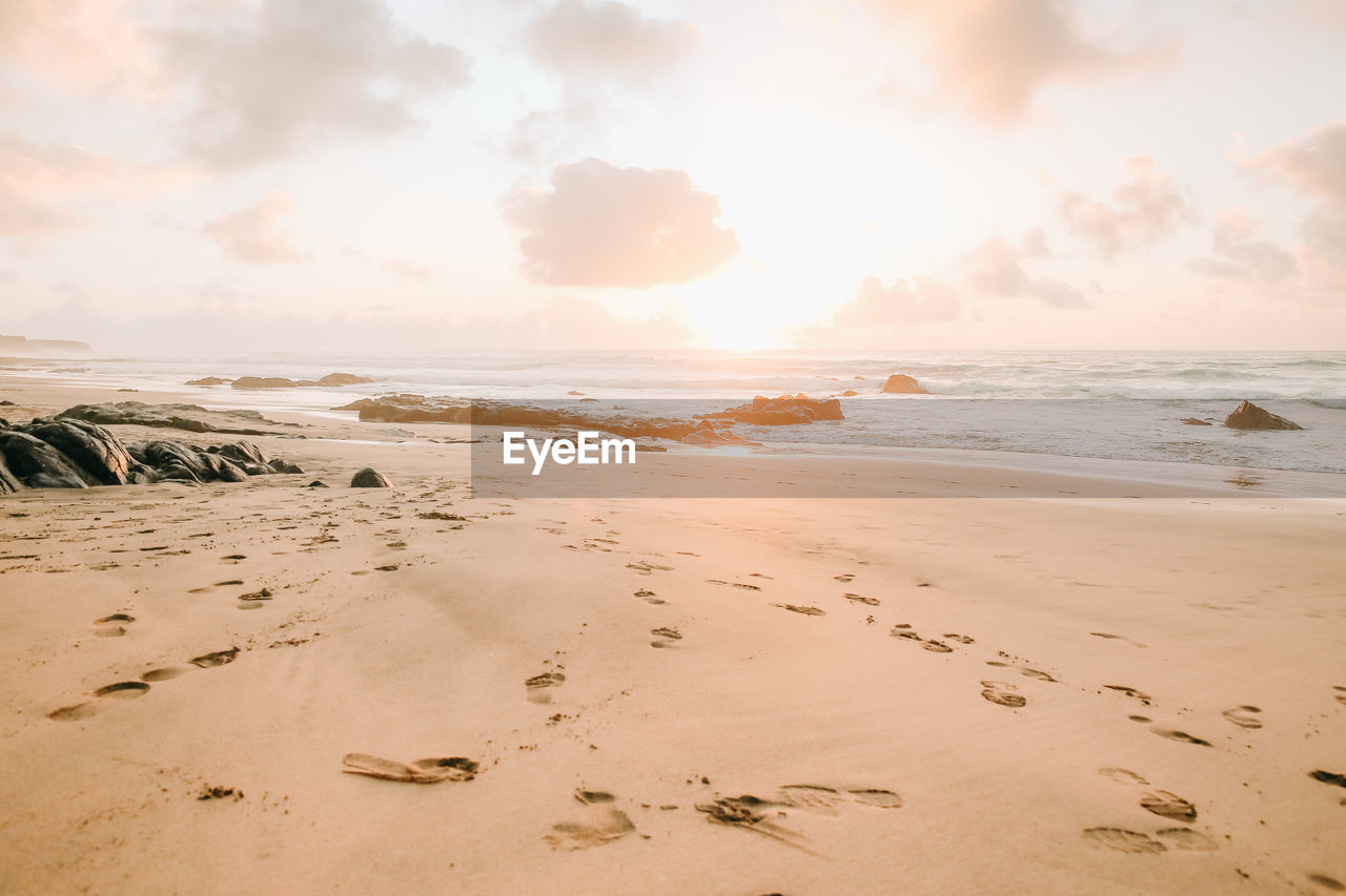 Scenic view of beach against sky during sunset