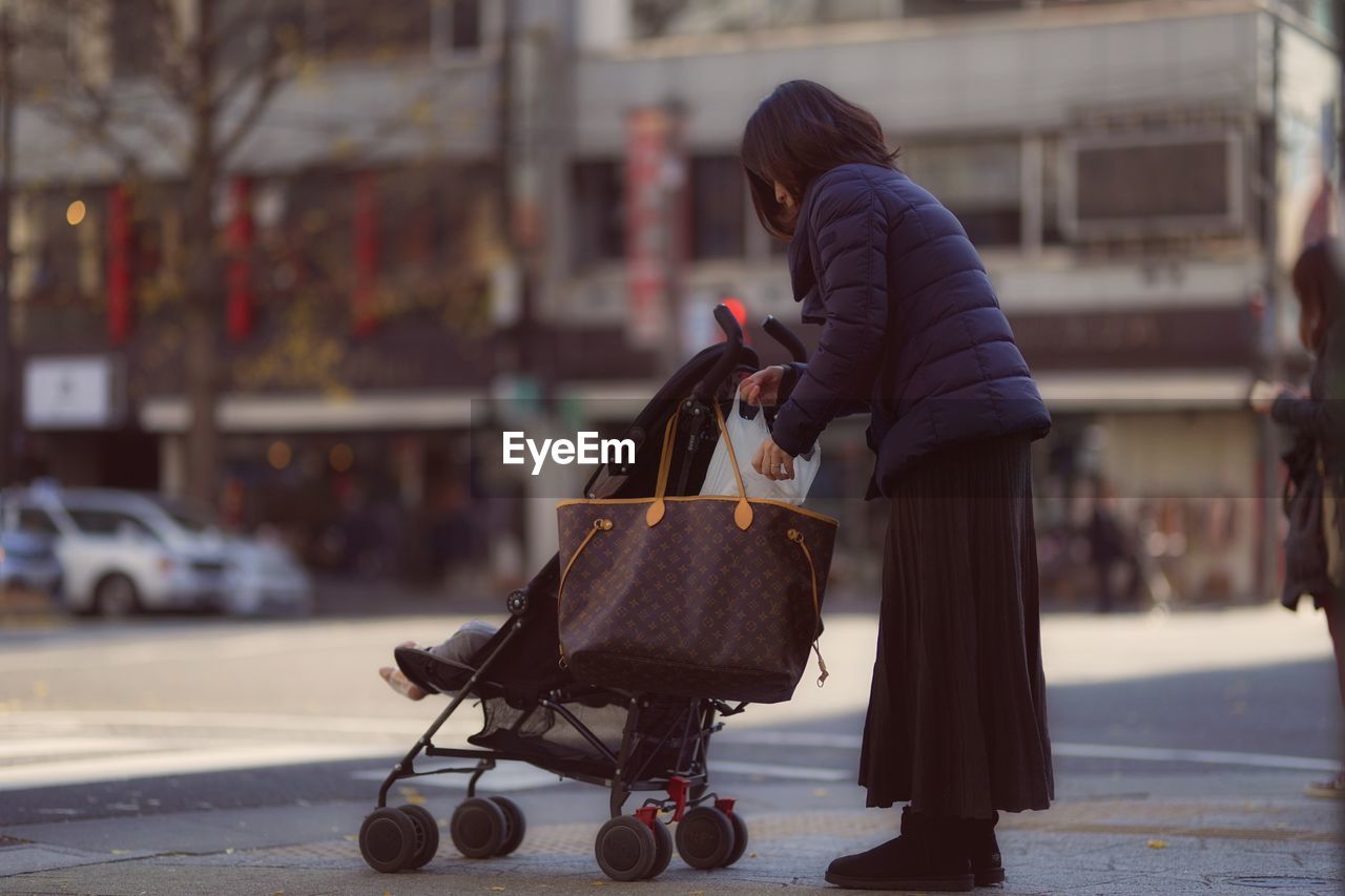 WOMAN ON STREET IN CITY