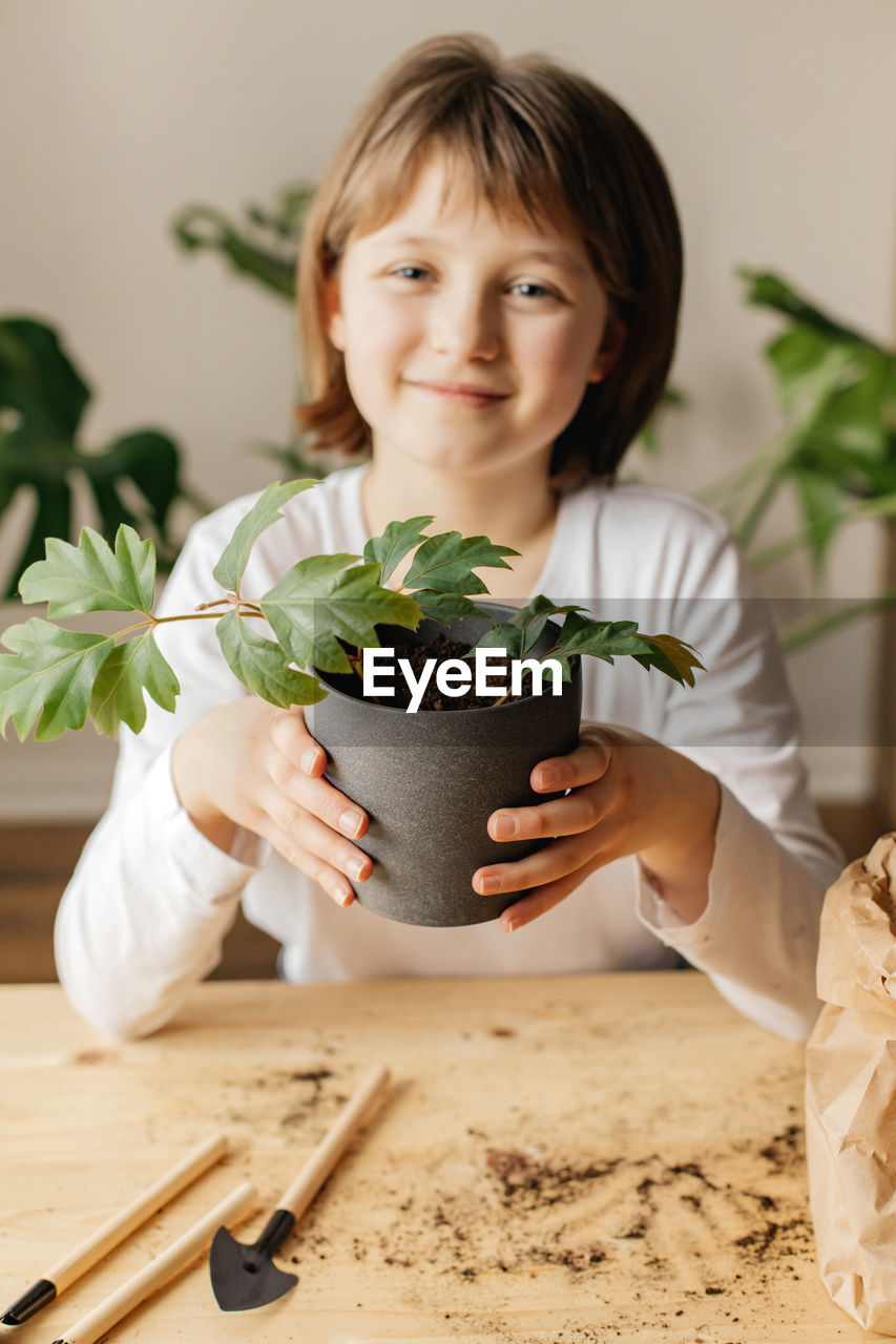 The girl collects soil in peat pots for planting seeds. spring gardening hobby for the whole family.