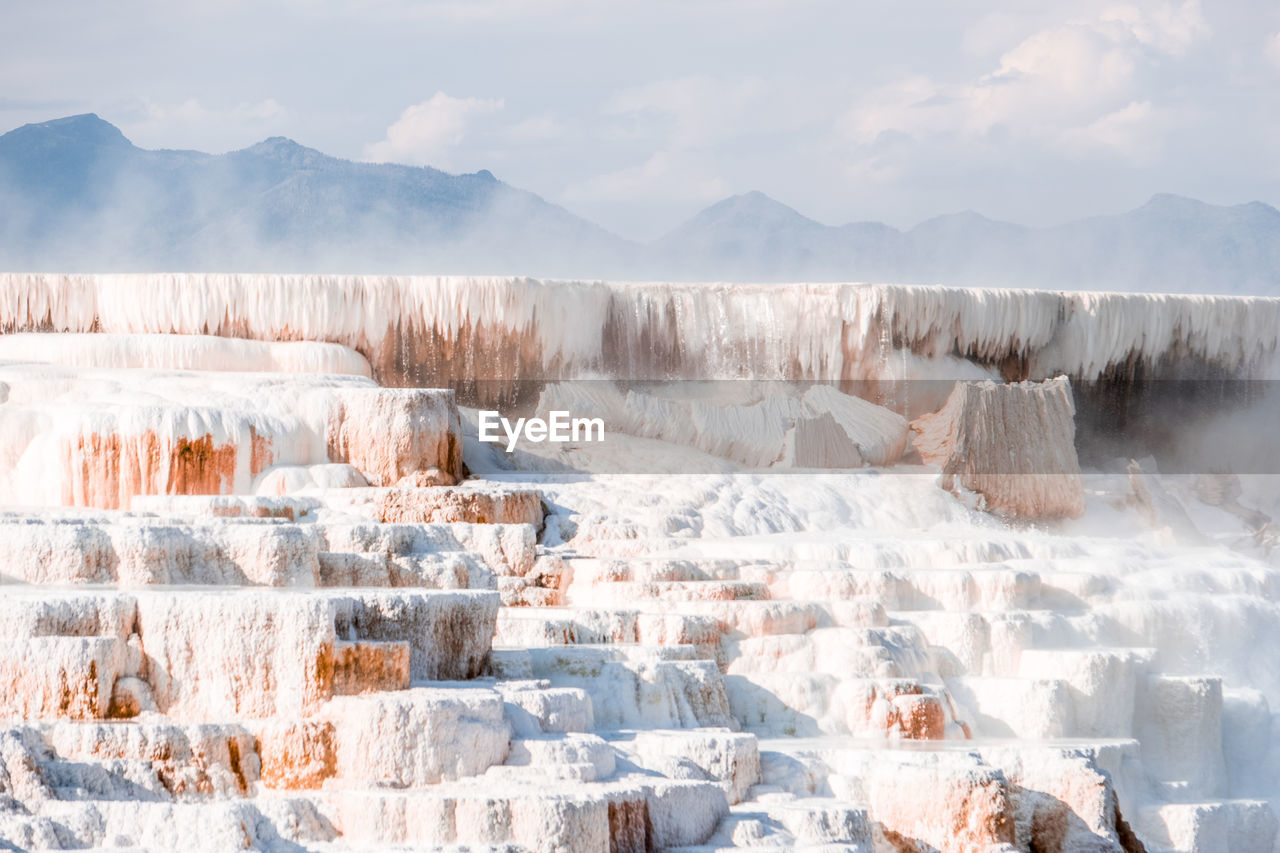 Panoramic view of snow covered land against sky