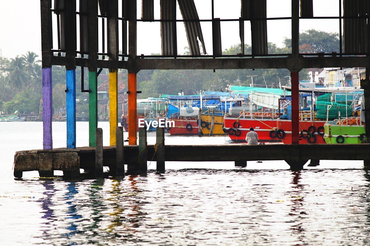 Colorful columns of pier in marina