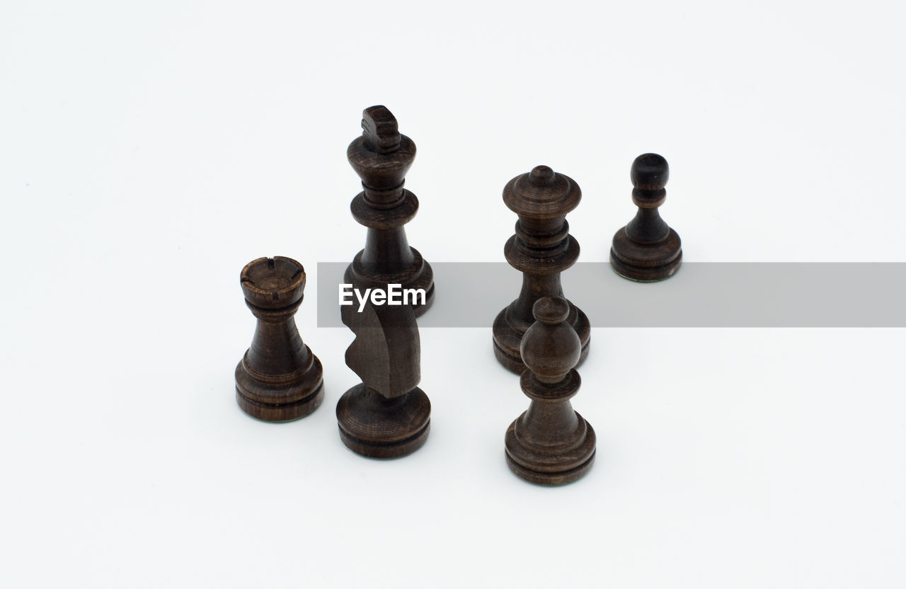 FULL FRAME SHOT OF CHESS PIECES AGAINST WHITE BACKGROUND