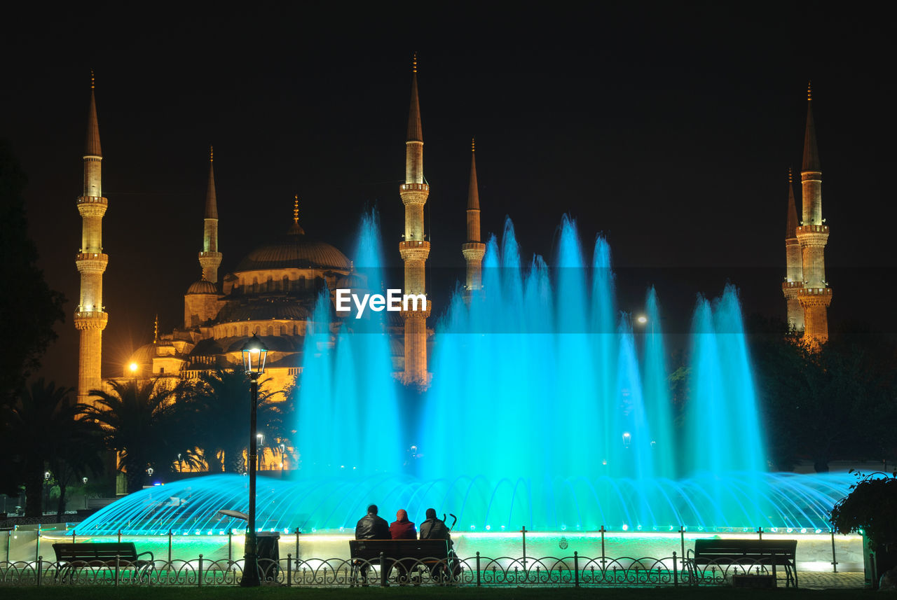 Fountain and blue mosque at night