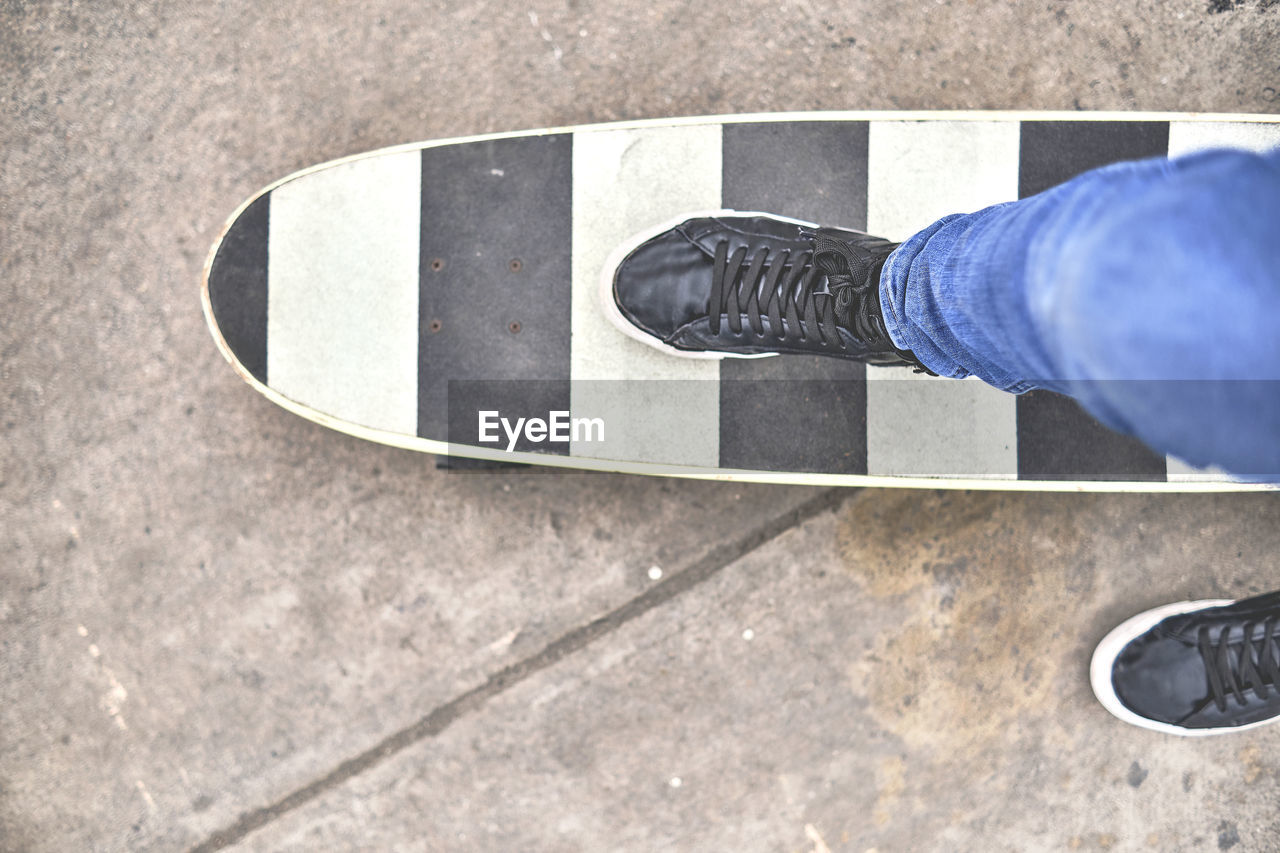 Young skateboarding on the streets, close up on shoes, transportation in the new normal