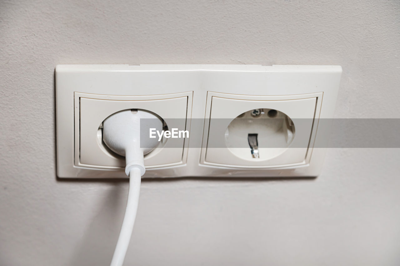 white, electricity, lighting, power plugs and sockets, wall - building feature, indoors, no people, cable, technology, outlet