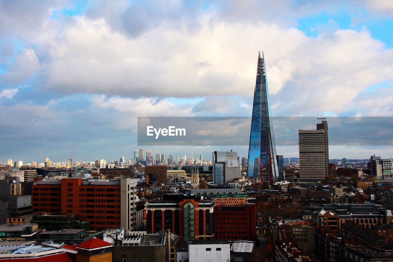 View of cityscape against cloudy sky