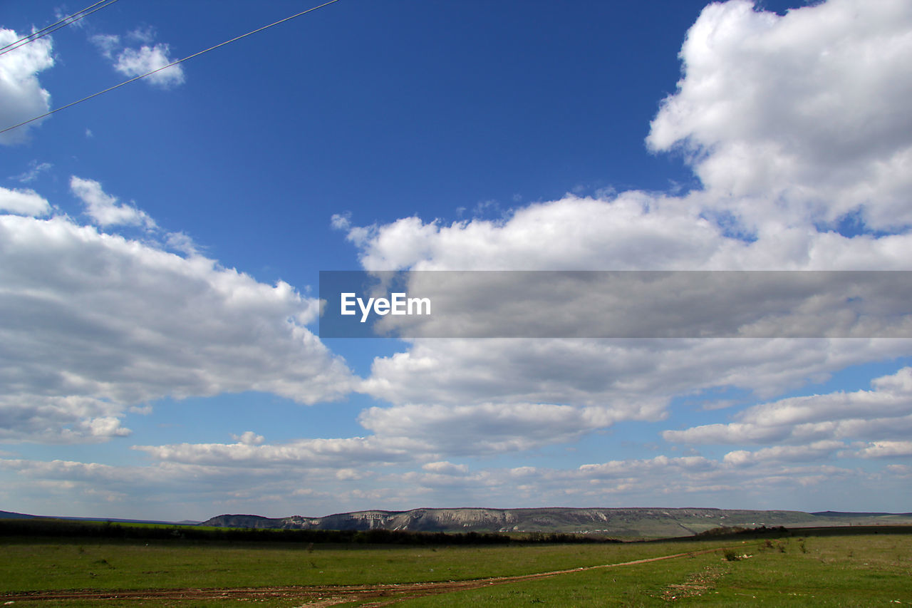 SCENIC VIEW OF LANDSCAPE AGAINST CLOUDY SKY