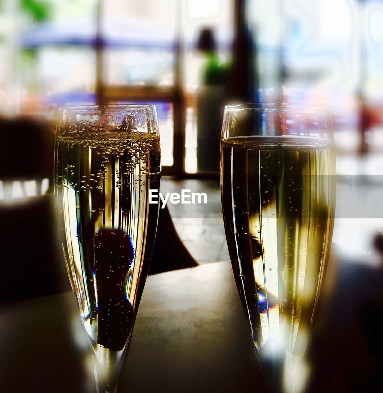 CLOSE-UP OF WINE GLASSES ON TABLE