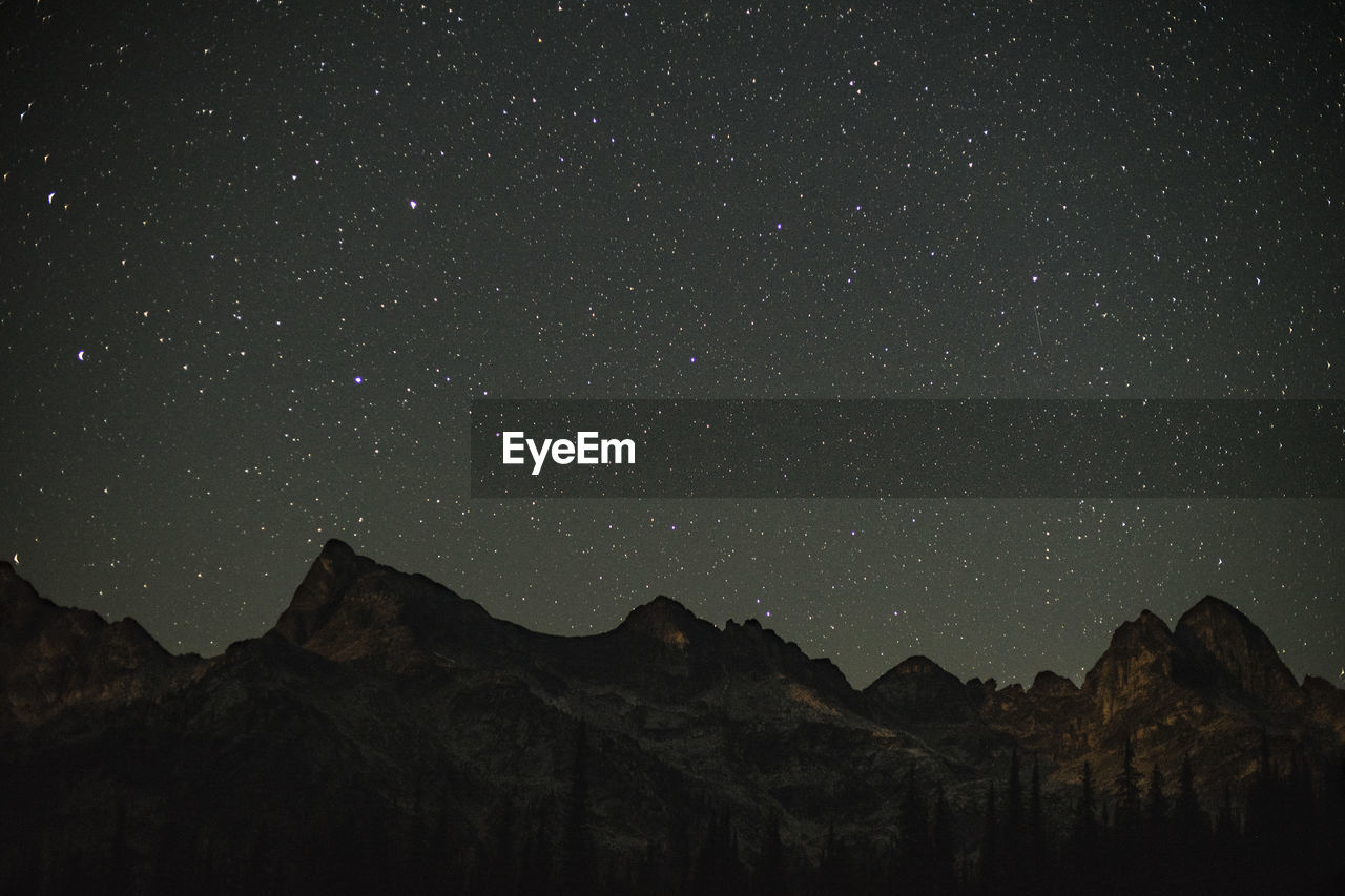 Low angle view of mountain against sky at night