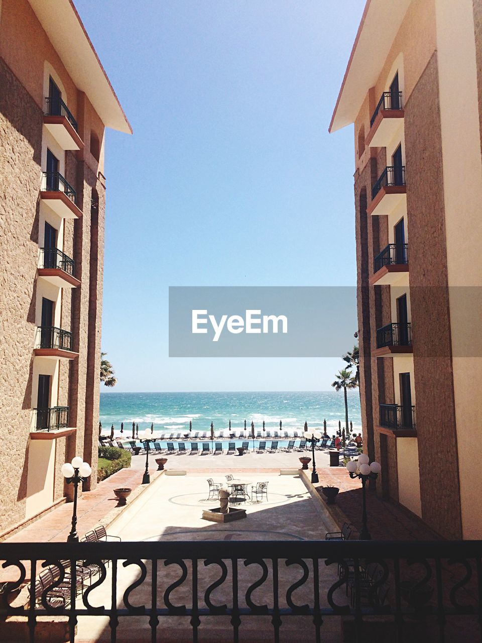 VIEW OF SWIMMING POOL BY SEA AGAINST CLEAR SKY