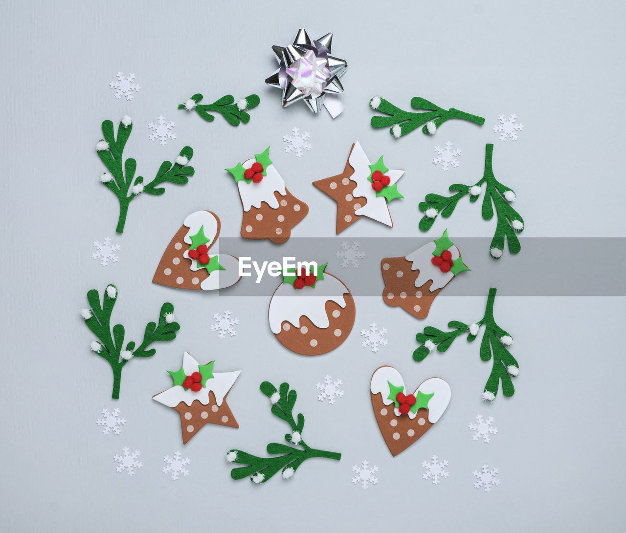 Abstract christmas background with gingerbread stars and bells stickers, mistletoe felt sprigs