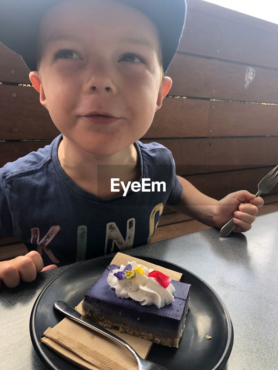 PORTRAIT OF BOY WITH CHOCOLATE ON TABLE