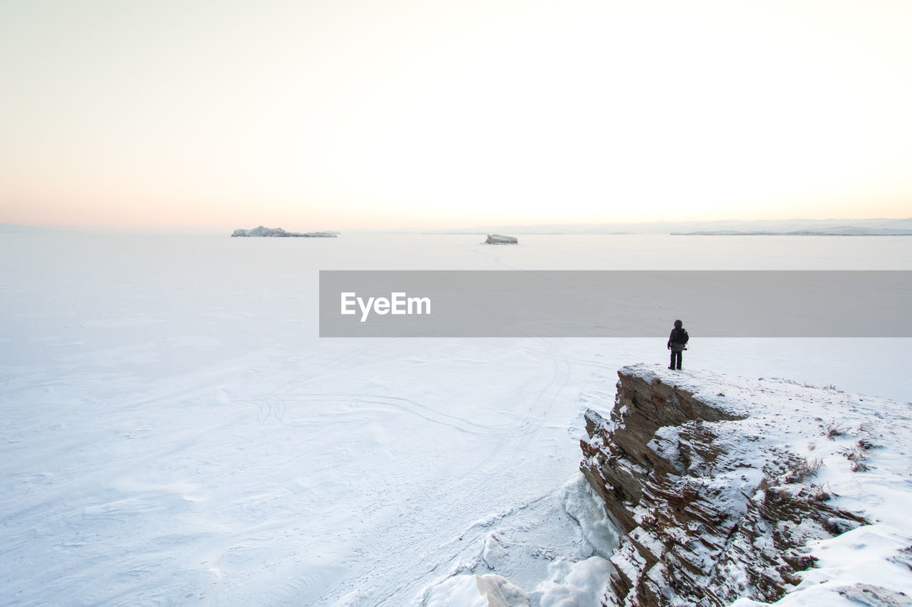 Scenic view of frozen lake against clear sky