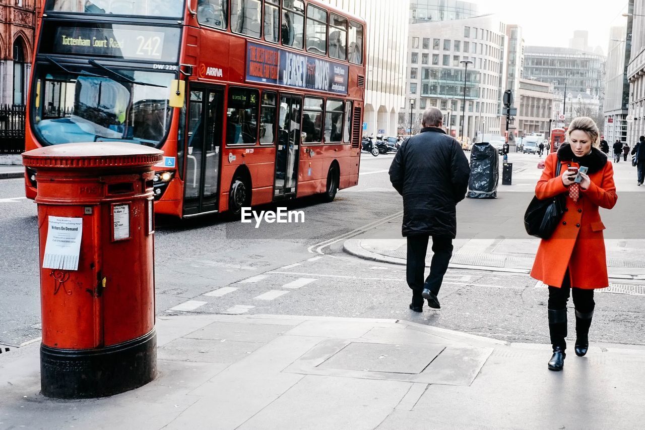 WOMAN STANDING ON CITY STREET