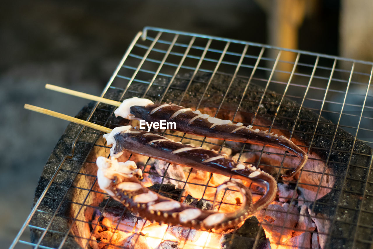 CLOSE-UP OF MEAT ON BARBECUE