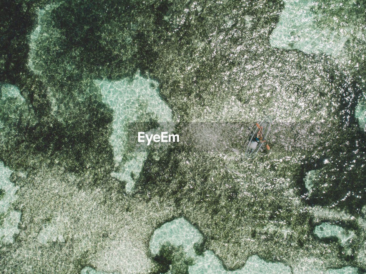 Aerial view of woman on inflatable boat in sea