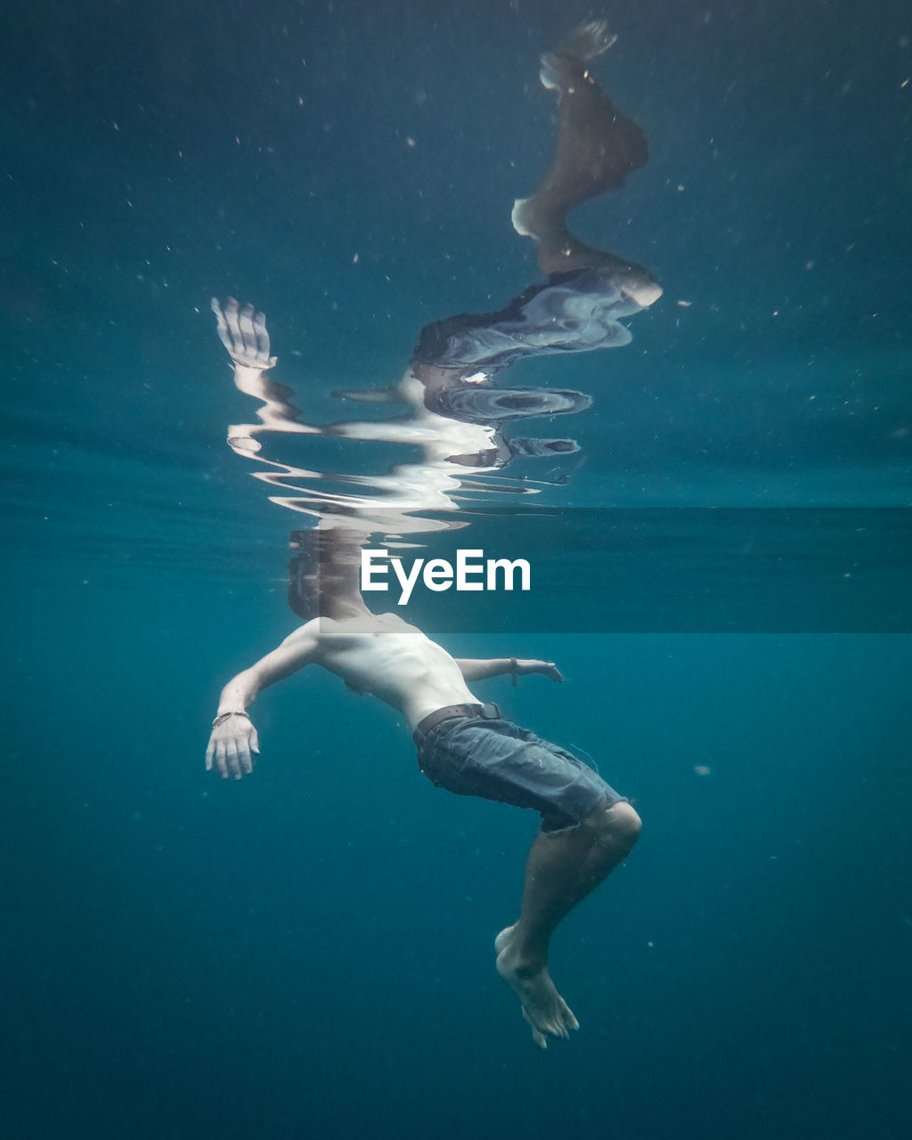 YOUNG MAN SWIMMING IN SEA