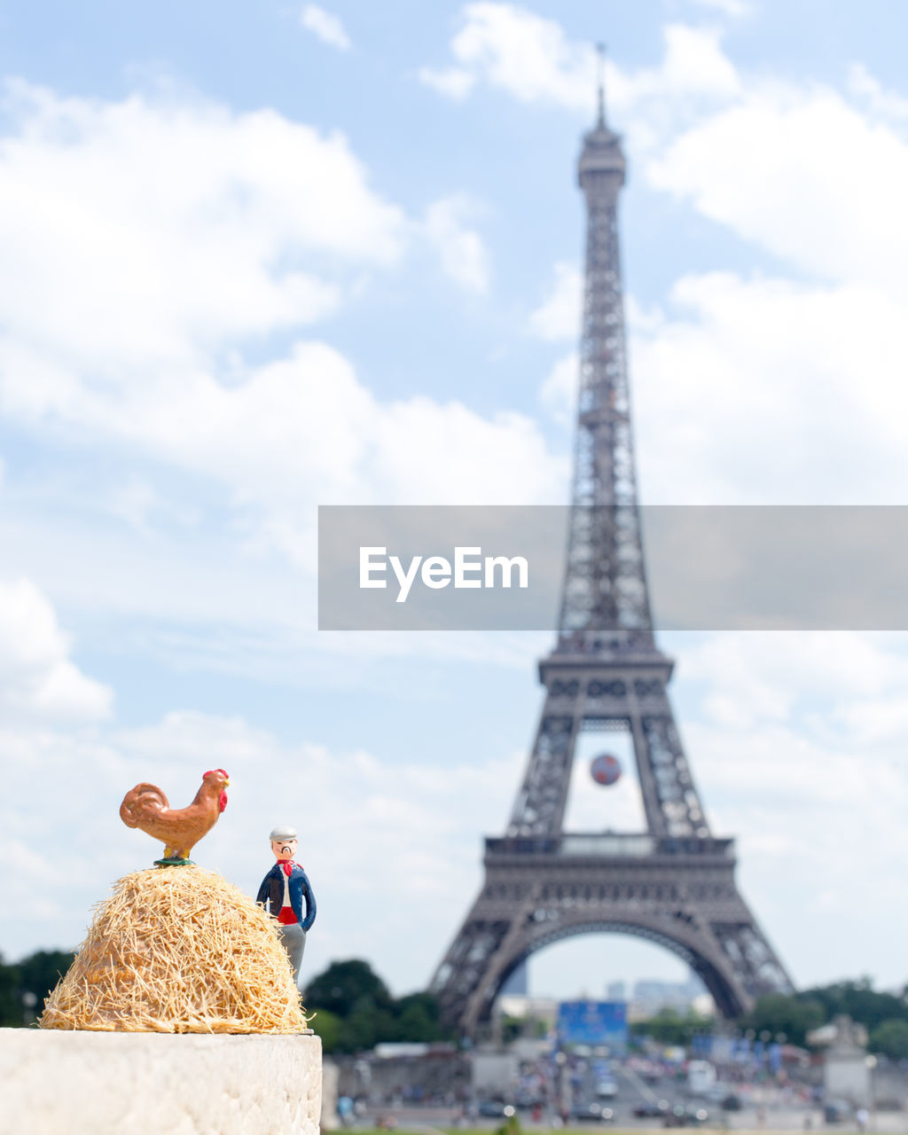 Figurines against eiffel tower in city