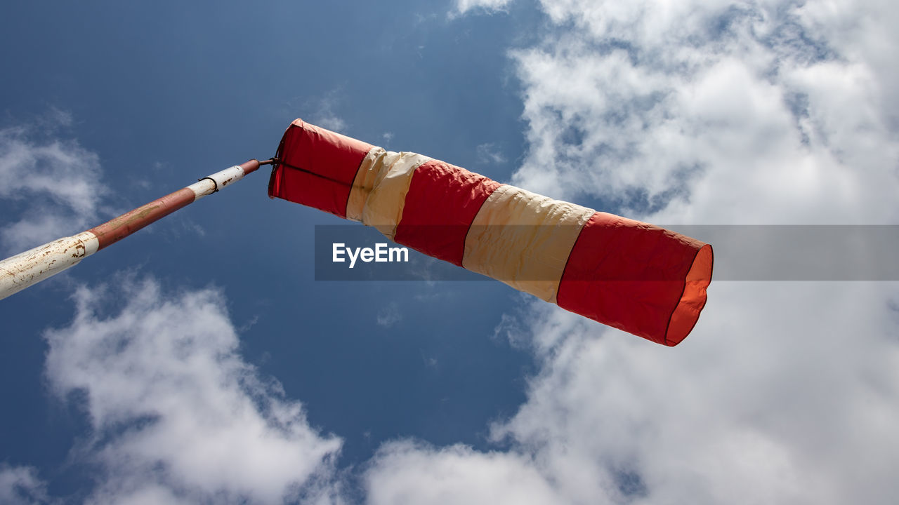 LOW ANGLE VIEW OF FLAG AGAINST CLOUDY SKY