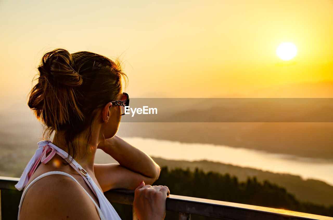Woman looking at sky during sunset