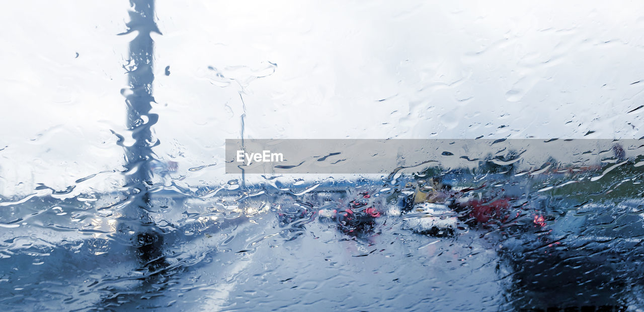 WATER DROPS ON GLASS WINDOW OF CAR