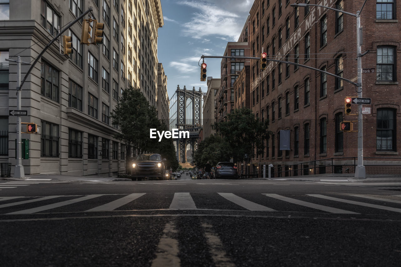 Manhattan bridge seen through buildings in city