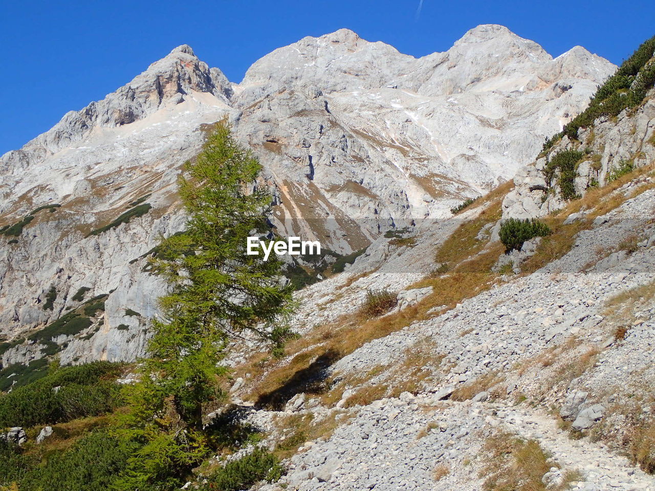 Low angle view of rocky mountains against clear sky