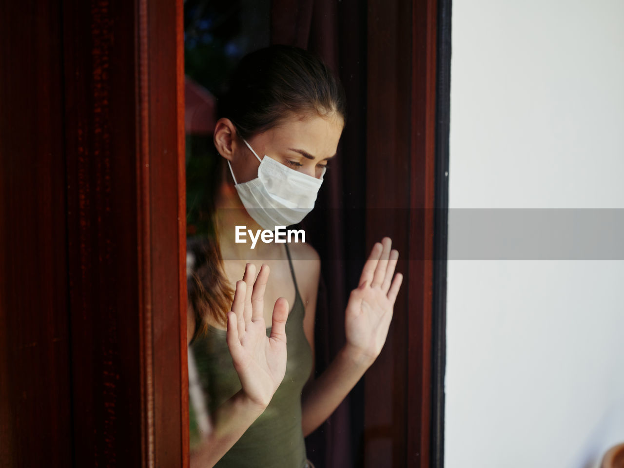 Portrait of woman standing by mirror