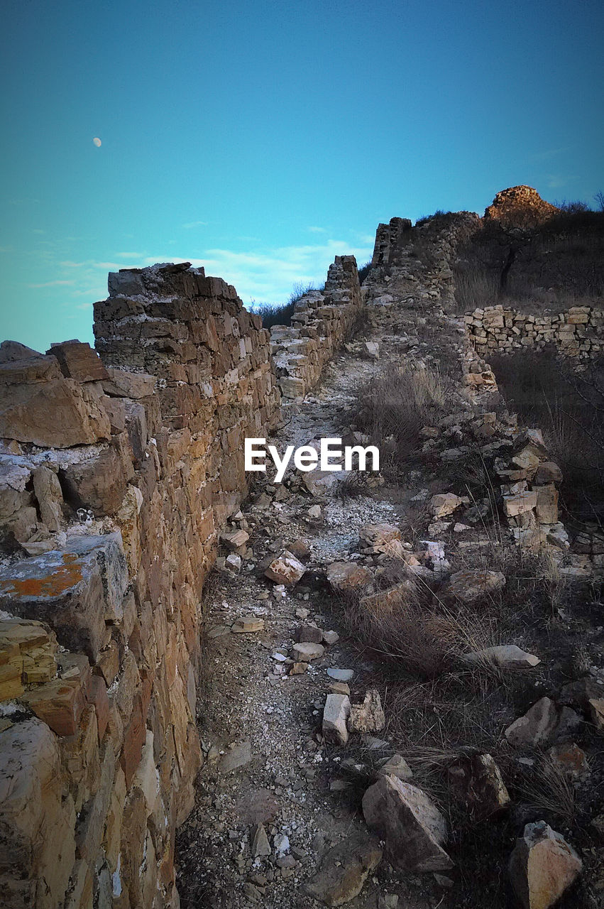 High angle view of abandoned wall against sky