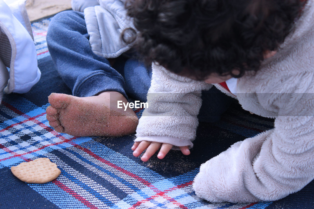 Baby boys sitting on picnic blanket